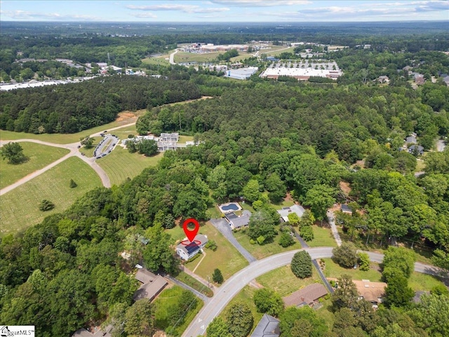 bird's eye view with a wooded view