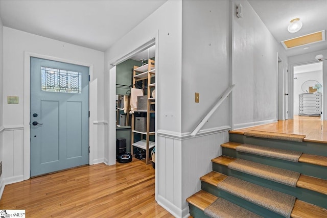 foyer entrance with stairs and light wood-style flooring