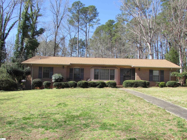 single story home with brick siding and a front lawn