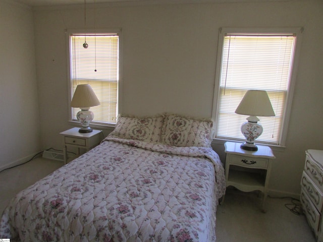 bedroom with multiple windows, light carpet, and ornamental molding