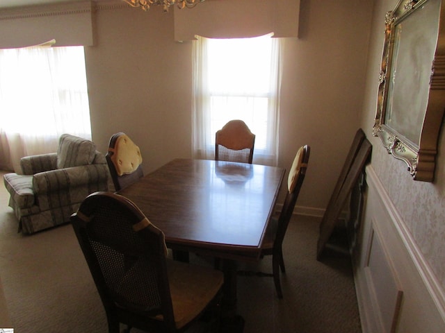 dining room featuring carpet flooring and a notable chandelier