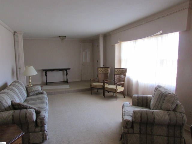 carpeted living area with crown molding and ornate columns