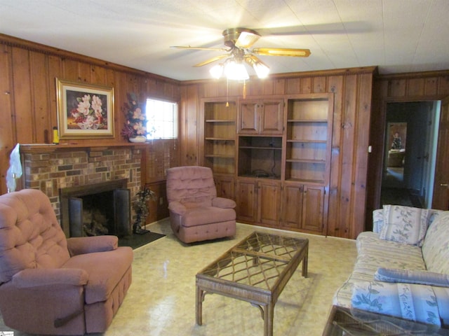 living area featuring ceiling fan, a brick fireplace, wood walls, light floors, and ornamental molding