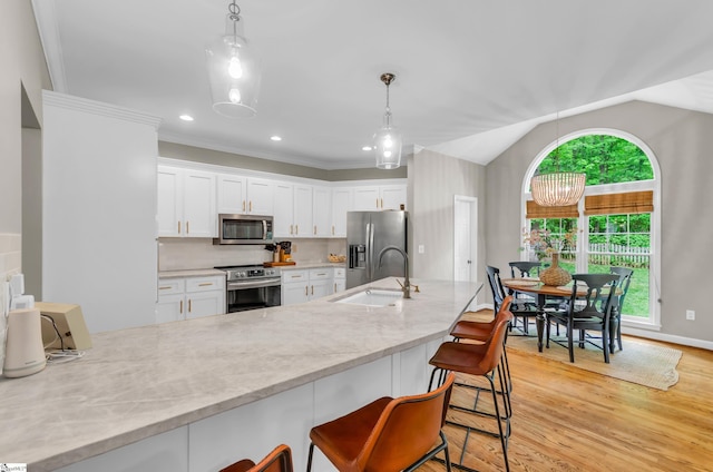 4 Barley Mill Dr, Greer, SC 29651 - kitchen featuring white cabinets, stainless steel appliances, a kitchen bar, and light wood-style flooring