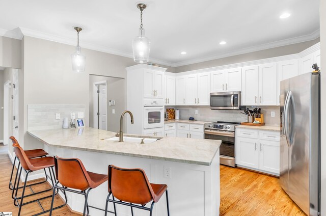 4 Barley Mill Dr, Greer, SC 29651 - kitchen featuring backsplash, appliances with stainless steel finishes, a sink, white cabinets, and a peninsula