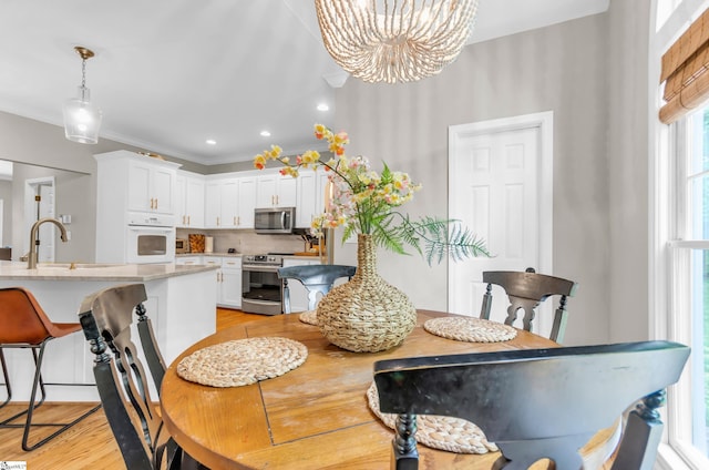 4 Barley Mill Dr, Greer, SC 29651 - dining space featuring crown molding, a chandelier, and light wood-style flooring