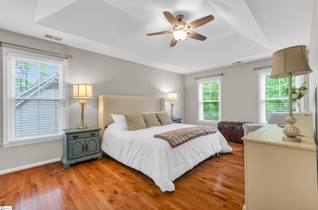 4 Barley Mill Dr, Greer, SC 29651 - bedroom with visible vents, baseboards, a tray ceiling, and light wood-type flooring