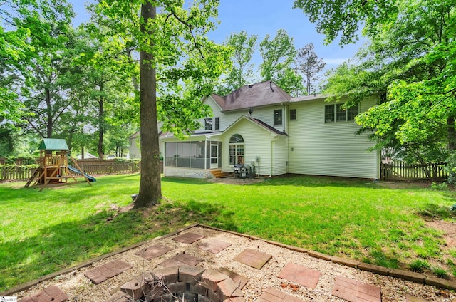 4 Barley Mill Dr, Greer, SC 29651 - back of property featuring a sunroom, a fenced backyard, a playground, a yard, and a fire pit