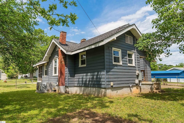 14 Damson St, Spartanburg, SC 29303 - view of home's exterior featuring central AC unit, fence, a yard, and a chimney