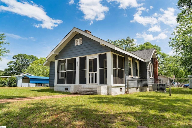 14 Damson St, Spartanburg, SC 29303 - back of property featuring a sunroom, roof with shingles, fence, and a yard