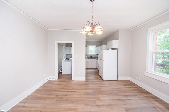 14 Damson St, Spartanburg, SC 29303 - unfurnished dining area with an inviting chandelier, light wood-style flooring, washer / dryer, and a wealth of natural light