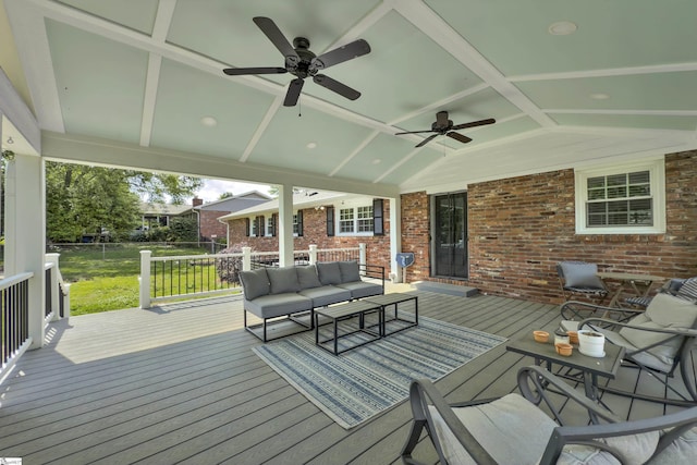 wooden deck featuring a lawn, ceiling fan, and outdoor lounge area