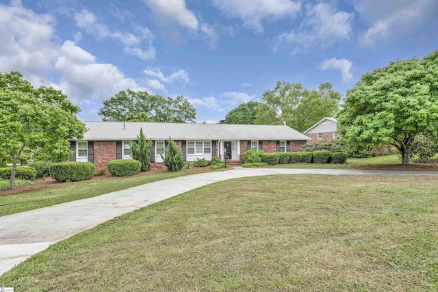 single story home with brick siding and a front yard