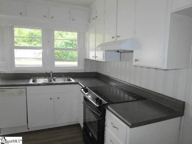 kitchen featuring white dishwasher, dark countertops, a sink, black / electric stove, and under cabinet range hood