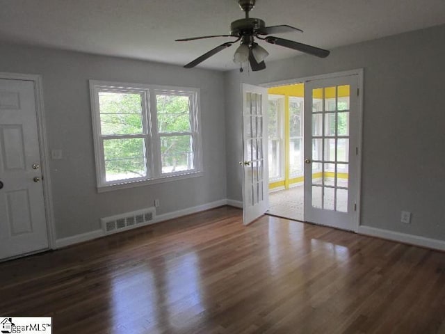 interior space featuring visible vents, baseboards, and wood finished floors