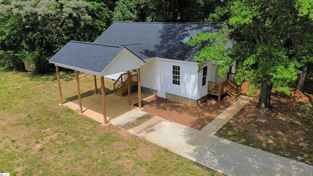 view of outbuilding with a carport and driveway