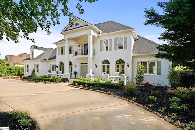 312 Stonebrook Farm Way, Greenville, SC 29615 - neoclassical home with covered porch, a shingled roof, and a balcony