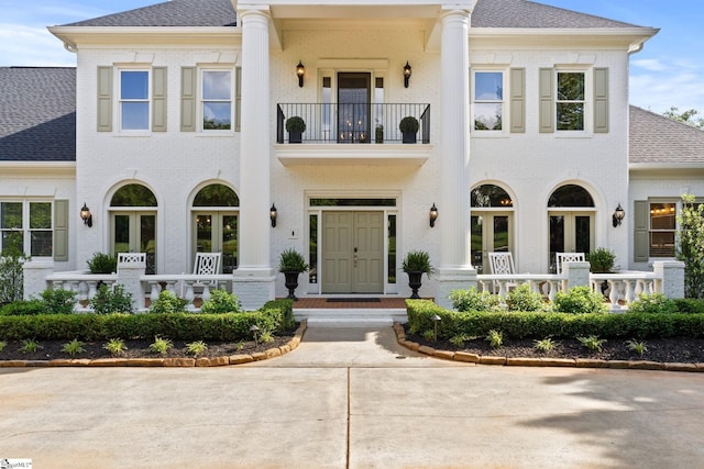 312 Stonebrook Farm Way, Greenville, SC 29615 - view of front of home featuring brick siding, a shingled roof, a balcony, and french doors