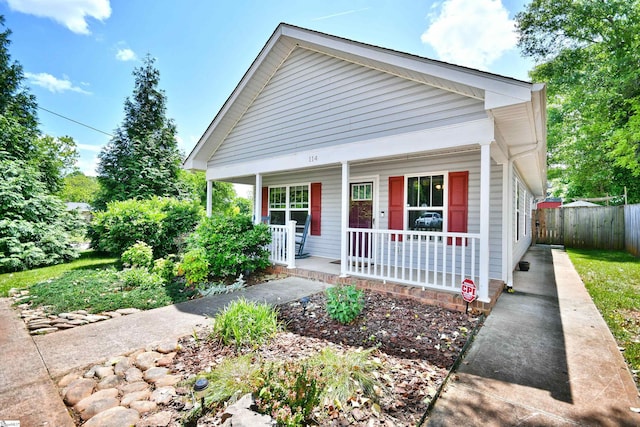 bungalow with a porch and fence