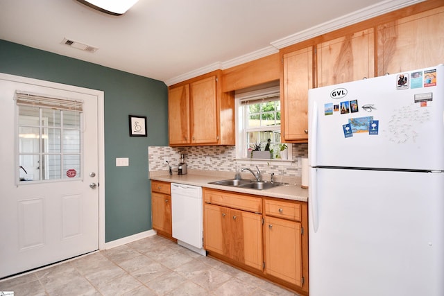 kitchen with backsplash, visible vents, a sink, light countertops, and white appliances