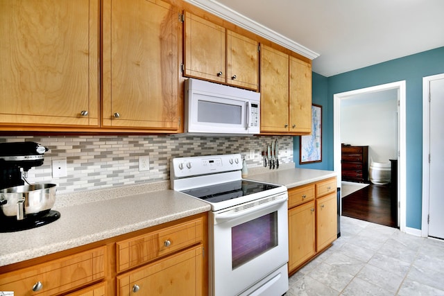 kitchen with white appliances, backsplash, baseboards, and light countertops