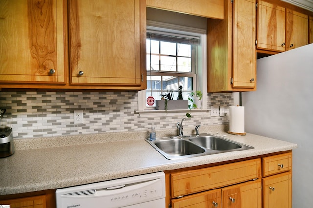 kitchen with a sink, light countertops, backsplash, and dishwasher