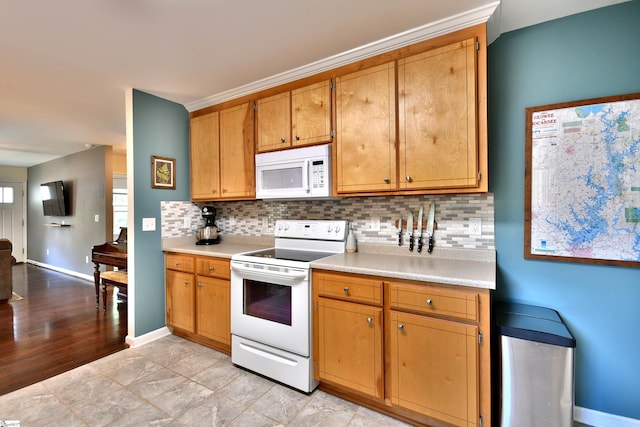 kitchen with white appliances, light countertops, and tasteful backsplash