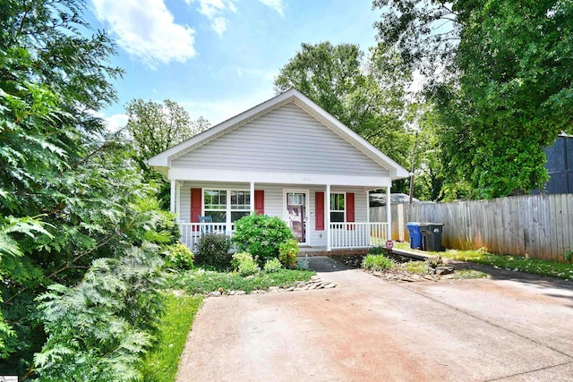 bungalow-style house with fence and covered porch