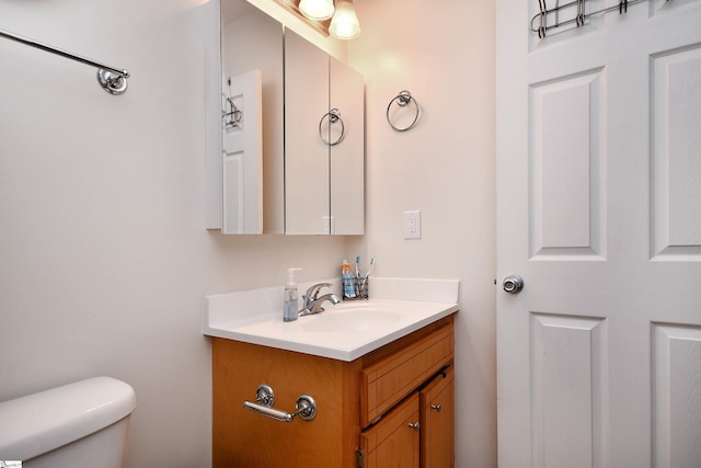 half bath with vanity and toilet