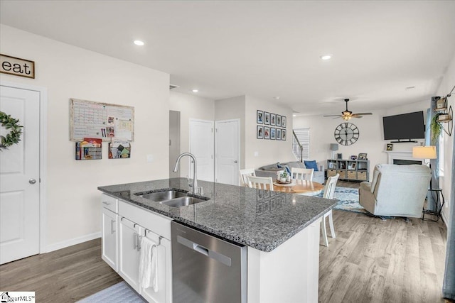 75 Oak Edge Ln, Greer, SC 29651 - kitchen with ceiling fan, stainless steel dishwasher, a sink, light wood-style floors, and an island with sink