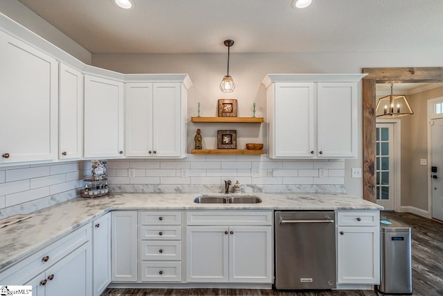kitchen featuring a sink, decorative backsplash, white cabinetry, and dishwasher