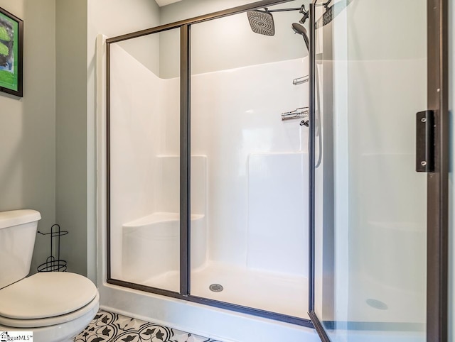 full bathroom featuring toilet and a shower stall
