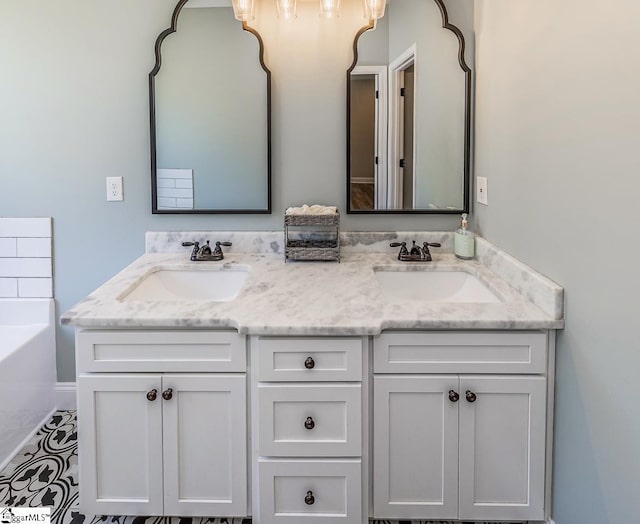bathroom featuring a sink, a bathing tub, and double vanity