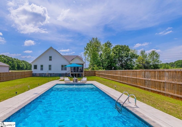 view of pool featuring a yard, a deck, a fenced backyard, and stairs