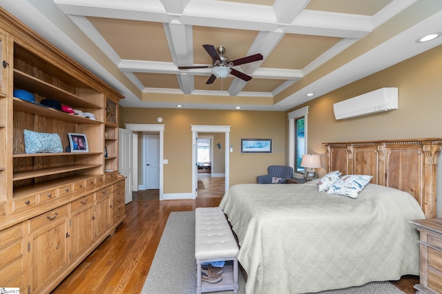 bedroom with light wood-style floors, a wall mounted air conditioner, baseboards, beamed ceiling, and coffered ceiling