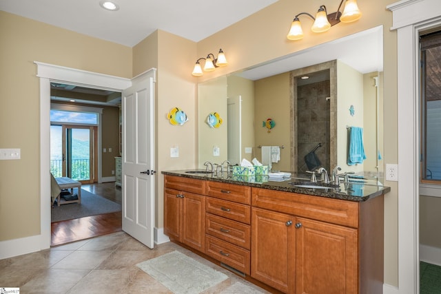 full bathroom with a sink, tile patterned flooring, double vanity, recessed lighting, and baseboards