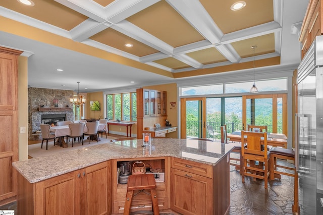 kitchen with crown molding, coffered ceiling, and a kitchen island