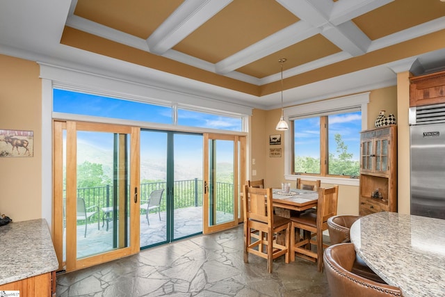 dining area featuring stone tile floors, coffered ceiling, beam ceiling, and a healthy amount of sunlight