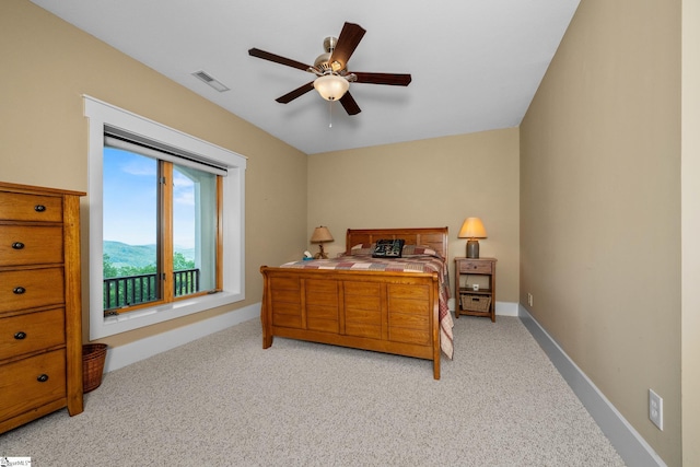 bedroom with visible vents, baseboards, ceiling fan, and light carpet
