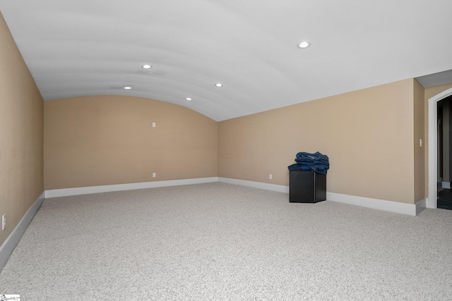 unfurnished room featuring recessed lighting, baseboards, vaulted ceiling, and light colored carpet