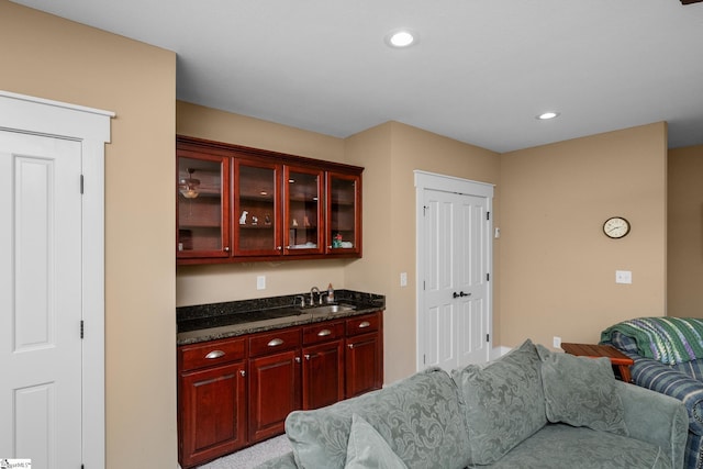 bar with a sink and recessed lighting