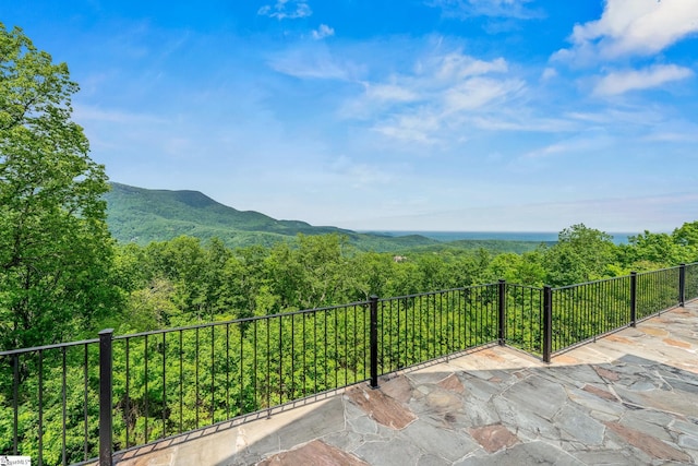 view of patio with a view of trees and a mountain view