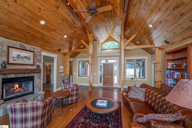 living area featuring wood ceiling, ceiling fan, a fireplace, wood finished floors, and recessed lighting