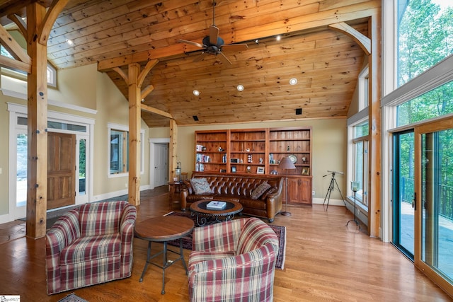 living room with wooden ceiling, high vaulted ceiling, baseboards, and ceiling fan