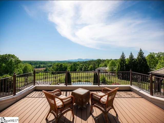 deck featuring a view of trees