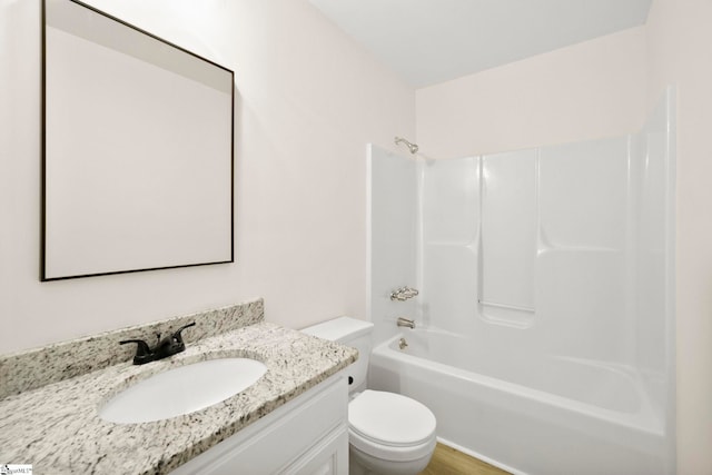 full bath with vanity, washtub / shower combination, toilet, and wood finished floors