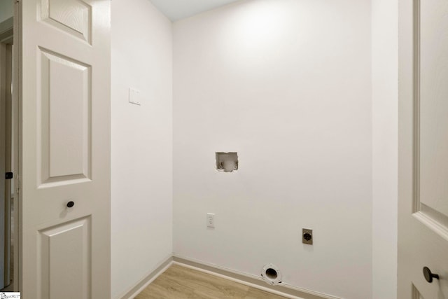 clothes washing area with laundry area, electric dryer hookup, baseboards, light wood finished floors, and hookup for a washing machine