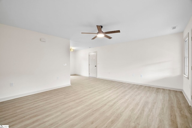 unfurnished room featuring baseboards, a ceiling fan, light wood-type flooring, and visible vents