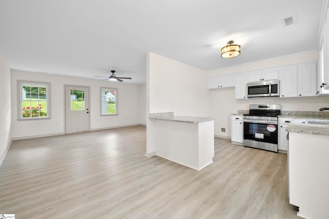 kitchen featuring ceiling fan, visible vents, light wood-style flooring, stainless steel appliances, and white cabinetry