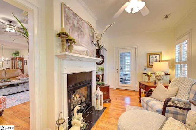 132 Hartsfield Dr, Easley, SC 29642 - living area featuring ceiling fan, visible vents, a fireplace, wood finished floors, and ornamental molding